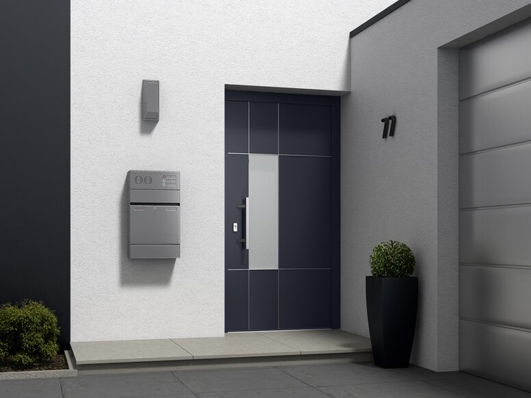 Front door with house number, birefbox, plant