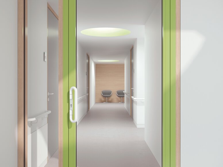 Glazed hospital door with green frame equipped with a lever handle in the colour signal white made of polyamide