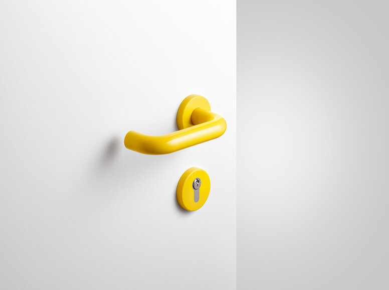 Béquille de porte avec rosace de clé en polyamide de couleur jaune moutarde