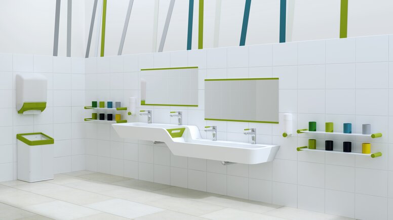 Plan de toilette adapté aux enfants avec des accents verts, lavabo avec graduation en hauteur et en profondeur intégrée à côté de barres de gobelets à dents colorées